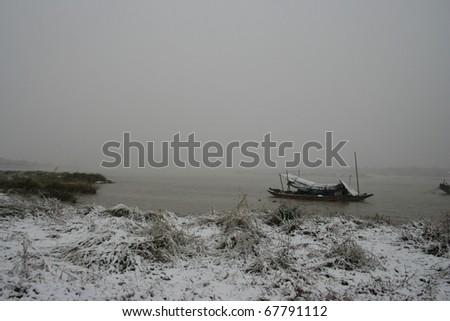 boat covered by snow in a river in South China