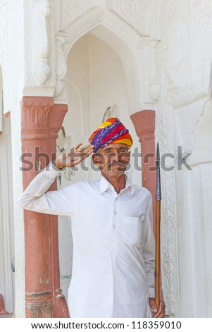 PUSHKAR, INDIA - OCT 20: Indian welcome from doorman with turban on October 20, 2012 in Pushkar, India. Turbans known as Pagaris in Rajasthan reflect the cast, culture, profession of the person.