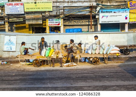 DELHI, INDIA - OCT 16: day worker wait for start of job on Oct 16,2012 in Delhi, India. Approximately 800000 slum dwellers try to get work as day laborer in Delhi.