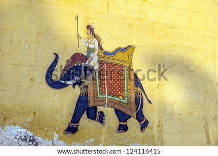 Colorful indian mural in the fort at Jodhpur showing a royal procession, including elephant  from the Rajput era