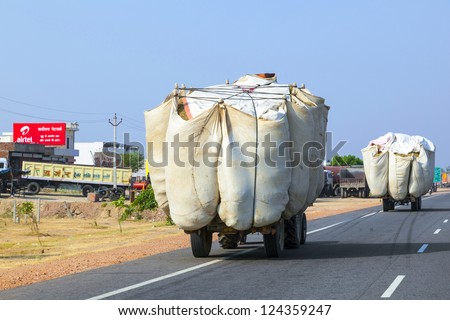 RAJASTHAN, INDIA - OCT 24: corn transport with traktor on highway on Oct 24, 2012 in Rajasthan, India. Roads is the dominant mode of transportation. They carry almost 65 percent of its freight.