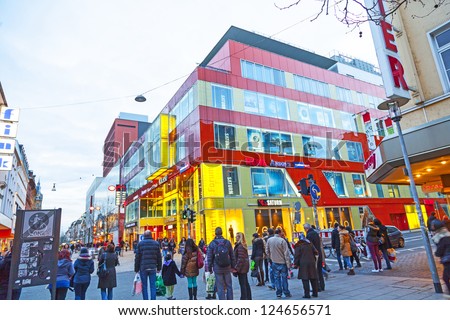 WIESBADEN, GERMANY - JAN 12: people shop in the pedestrian area on JAN 12,2013 in Wiesbaden, Germany. This central shopping zone offers a large variety of shops and stretches out for one kilometer..