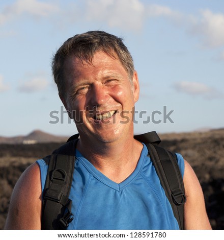 man on walking trail thru volcanic area in Lanzarote