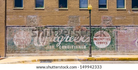 LAKE CHARLES, USA - AUGUST 9:   old painted advertising at the wall on August 9, 2013 in Lake Charles, USA. Painted ads on brick walls were common in the first alf of last century in america.