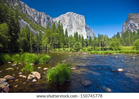 view to western rocket plateau of yosemite national park seen from beautiful Merced river
