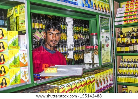 NUWARA ELIYA, SRI LANKA - AUGUST 14: pharmacists sells medicine in his shop on August 14, 2005 in Nuwara Eliya, Sri Lanka. He offers traditional Ayurveda as well as western medicine.