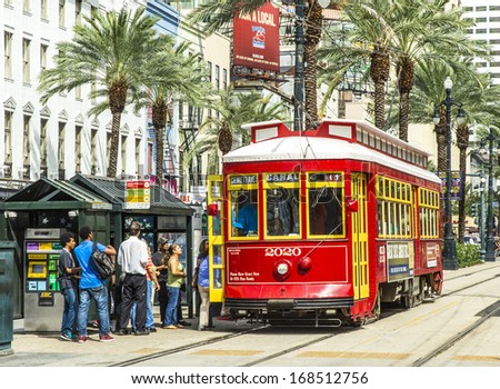 NEW ORLEANS - JULY 16: people travel with the Street car Canal street line St. Charles line on July 16, 2013 in New Orleans, USA.  It is the oldest continually operating street car line in the world.