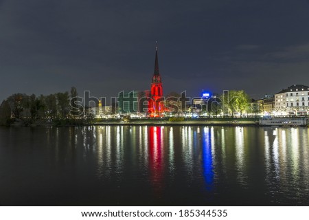 FRANKFURT - APRIL 4: Illuminated  church at river Mainat night on April 4, 2014 in Frankfurt, Germany. The festival Luminale takes place in Frankfurt every 2 years and lasts one week.