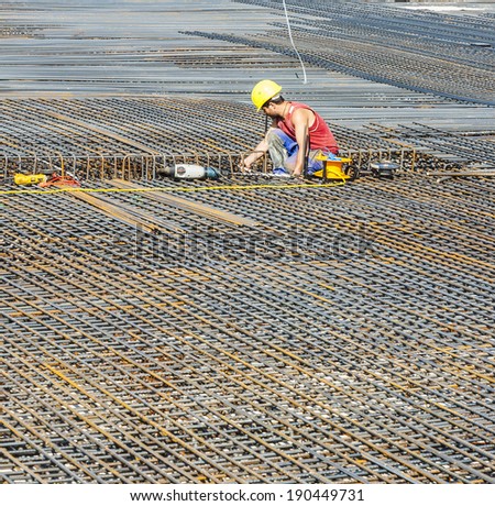 HOFHEIM, GERMANY - SEP 25: worker does the steel bars construction at a site on Sep 25, 2009 in Hofheim, Germany. The construction is checked by the Bauamt.