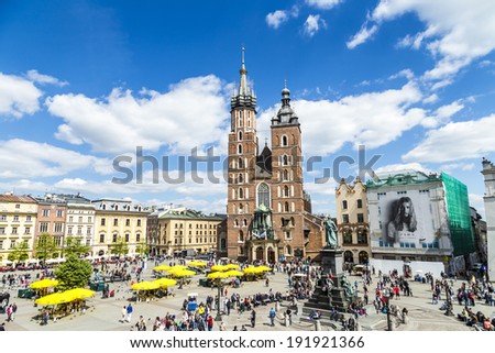 KRAKOW, POLAND - MAY 5, 2014: Tourists at the Market Square in Krakow . Main Market Square, one of the largest medieval squares in Europe, was built in 1257.