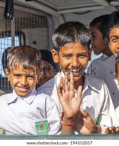 JAIPUR, INDIA - NOVEMBER 12, 2010: Unidentified pupils ride in a public bus to school in Jaipur, India. Schools do not provide shared bus transportation in India.