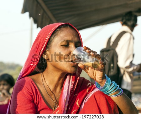 DELHI - NOVEMBER 8, 2011: woman drinking tea at the Meena Bazaar Market in Delhi, India. Shah Jahan founded the bazaar in the 17th century inspired by the Isfahan Bazaar.