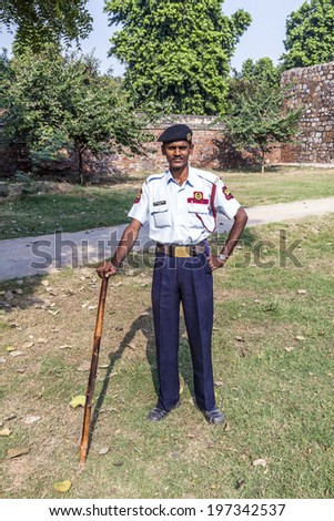 DELHI, INDIA - NOV 11, 2011: guard in the garden of  Humayun\'s tomb, built by Hamida Banu Begun in 1565-72 A.D. in Delhi, India. The earliest example of Persian influence in Indian architecture.