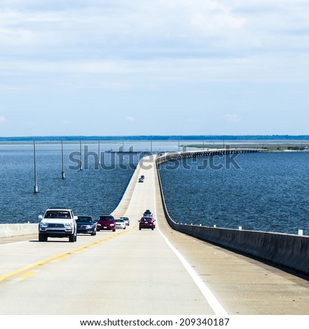 DAUPHIN ISLAND, USA - JULY 18, 2013: crossing the Dauphin Island Bridge in Dauphin Island, USA. The original bridge opened on July 2, 1955 under the name Gordon Persons bridge.