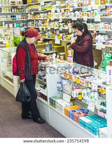 San Francisco, USA - JULY 24, 2008: woman buys medicine in a pharmacy in china town in San Francisco, USA. San Francisco is the biggest chinese City outside of China.