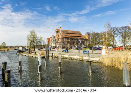 WOLGAST, GERMANY - APRIL 15, 2014: view to riverside of old village of Wolgast, Germany. The harbor at peene river ist restored ansd serves as tourist attraction.