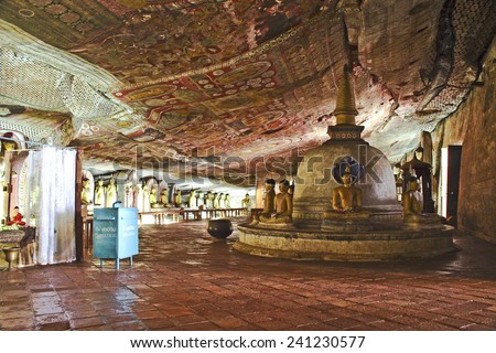 DAMBULLA, SRI LANKA - AUG 9, 2005: Buddah and painting in the famous rock tempel in Dambullah, Sri Lanka. This temple complex dates back to the 1st century BC.
