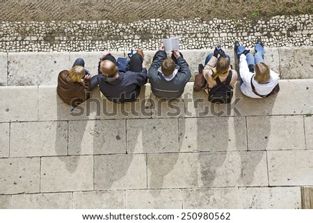 LISBON, PORTUGAL - DEC 30, 2008: people have a rest at the marble stones  of Jeronimos Monastery in Lisbon, Portugal. Jeronimos Monastery was completed in 1544 and is UNESCO World Heritage Site.