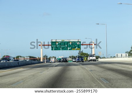 MIAMI, USA - AUG 27, 2014: driving the Miami Highway from the airport direction East in Miami, USA. Sunpass lane on left hand side is for toll only.