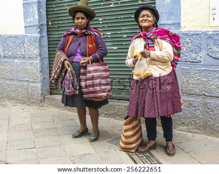CUZCO, PERU - JAN 18, 2015: poor people beg for an alm and sell handcraft and fruits to tourists in Cuzco, Peru.