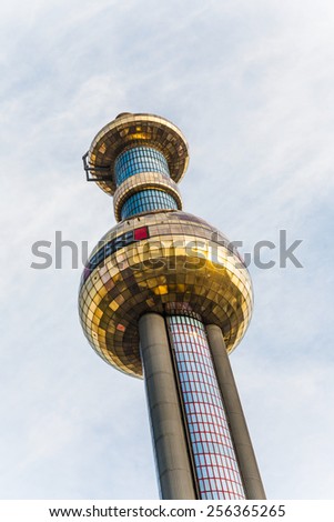 VIENNA, AUSTRIA - APRIL 25, 2009: The chimney of the most famous District heating in Vienna of artist Hundertwasser in intensive afternoon light in Vienna, Austria.