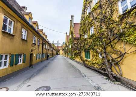 AUGSBURG, GERMANY - APRIL 29, 2015: The Fuggerei is the worlds oldest social housing complex still in use in Augsburg, Germany.