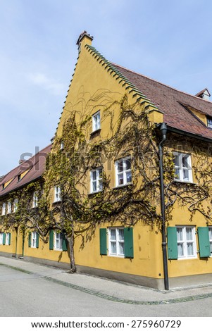 AUGSBURG, GERMANY - APRIL 29, 2015: The Fuggerei is the worlds oldest social housing complex still in use in Augsburg, Germany.