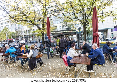 BERLIN, GERMANY - OCT 27, 2014: old vintage Kiosk name is renamed to oval office and people enjoy on tables the autumn summer in Berlin, Germany.