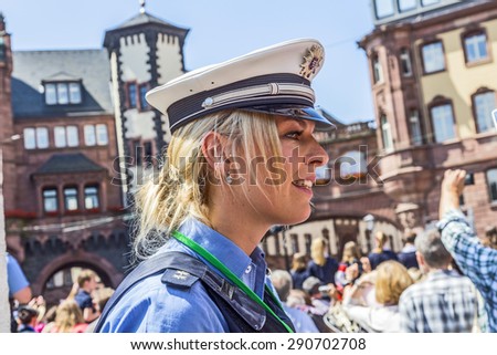 FRANKFURT, GERMANY - JUNE 26, 2015: friendly police woman pays attention for the visit of queen Elizabeth II at the Roemer market square in Frankfurt, Germany.
