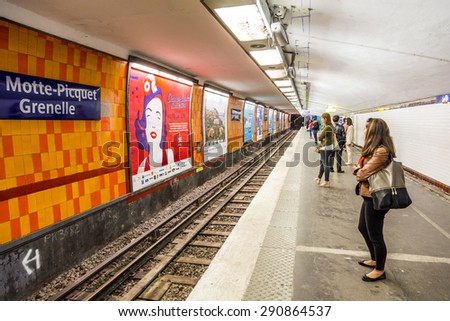 PARIS , FRANCE- JUNE 10, 2015: Tourists and locals on a subway train station in Paris, France. More than 30 million people visit Paris annually.