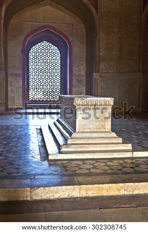 DELHI, INDIA - NOVEMBER 11, 2011: marble tomb inside  Humayuns tomb in Delhi, India. The tomb was commissioned by Humayun\'s first wife Bega Begum in 1569.
