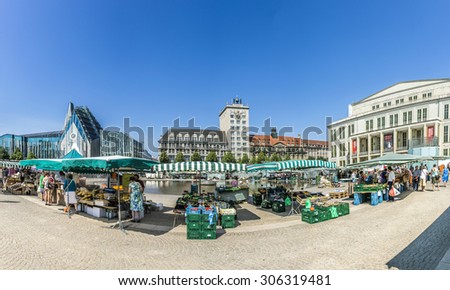 LEIPZIG, GERMANY - AUG 8, 2015: Old Town Hall in Leipzig with people at marketplace. In about 1165, Leipzig was granted municipal status and market privileges.