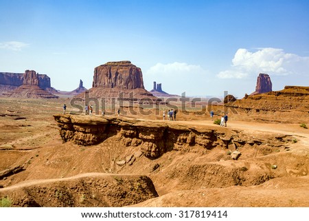 MONUMENT VALLEY, USA - JULY 12, 2008: people enjoy the view from John Fords place to the scenic Buttes in Monument Valley, USA.