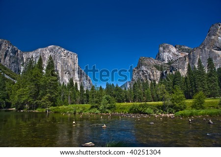 view to western rocket plateau of yosemite national park seen from beautiful Merced river