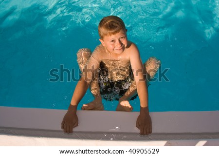 child is posing in the pool and makes fun