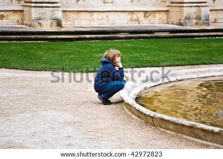 boy visiting the beautiful Jeronimos Monastery in Lisbon, Belem, not amused