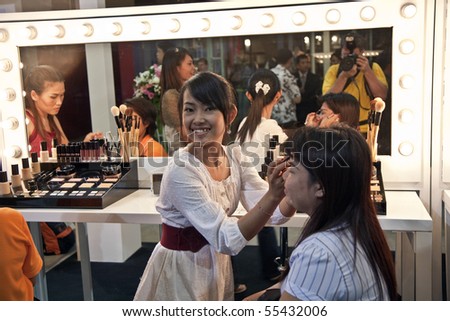 BANGKOK, THAILAND - MAY 11: cosmetic company AMWAY sponsors a makeup course with its products in the central world center and assists woman in using products, May 11, 2009 in Bangkok, Thailand