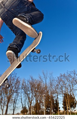 boy with skate board going airborne