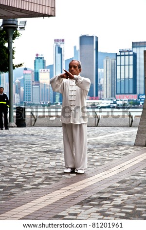 HONG KONG - JANUARY 8: Tai Chi Public Exercising in early morning at January 08, 2010 in Hongkong.  The old teacher teaches younger people to learn Tai Chi in the harbor area to keep tradition alive.