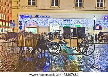 VIENNA, AUSTRIA - NOV 26:  horse drawn fiaker at the Stephans Dome  by night on November 26,2010 in Vienna, Austria. Since the 17th century, the horse-drawn carriages characterize Viennas cityscape.