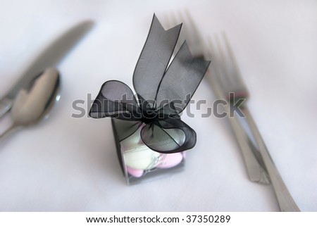 Small container of mints on table at wedding place setting