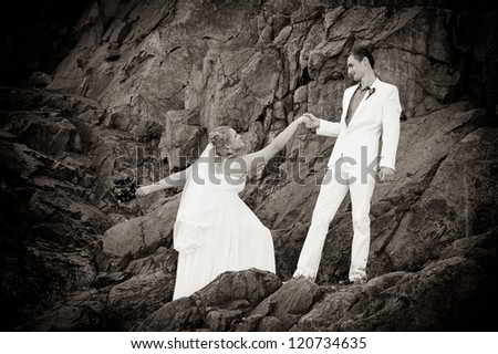 Happy young bride and groom outside on the mountain on their wedding day - Copyspace. Wedding couple - new family! wedding dress. Bridal wedding bouquet of flowers