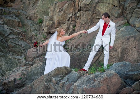 Happy young bride and groom outside on the mountain on their wedding day - Copyspace. Wedding couple - new family! wedding dress. Bridal wedding bouquet of flowers