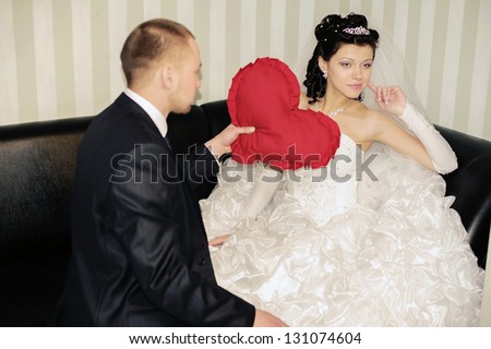 wedding couple hugging, groom gives his bride a red heart. Valentine\'s Day