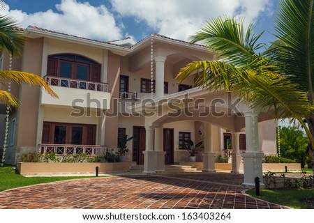 Luxurious villa in Dominican Republic. Beautiful villa with an own swimming pool. villa on luxury Caribbean resort with beautiful garden. Classical spanish villa among flowers, not far from ocean.