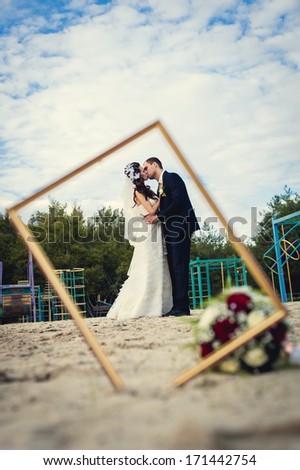 Wedding couple in the frame. Portrait of happy bride and groom.
