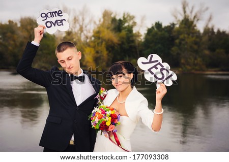 Wedding on the nature. couple in love bride and groom with a bouquet at bridal day in summer. Enjoy a moment of happiness and love and having fun with funny false mustache. playful newlywed family