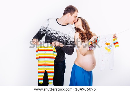Pregnant young beautiful woman and man isolated on white background. happy pregnant couple isolated on white. Waiting for the baby / Young pregnant women with her husband