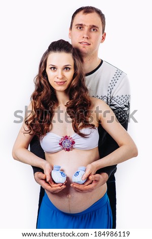 Pregnant young beautiful woman and man isolated on white background. happy pregnant couple isolated on white. Waiting for the baby / Young pregnant women with her husband