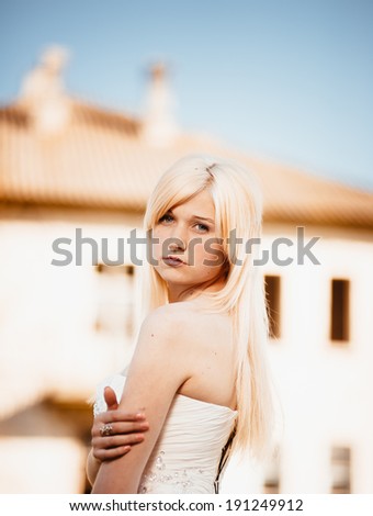 Beauty Girl Outdoors enjoying nature. Beautiful Teenage Model girl in white dress on the Spring Field, Sun Light. bride enjoying walking in spring forest.Free Happy Woman. Toned in warm colors